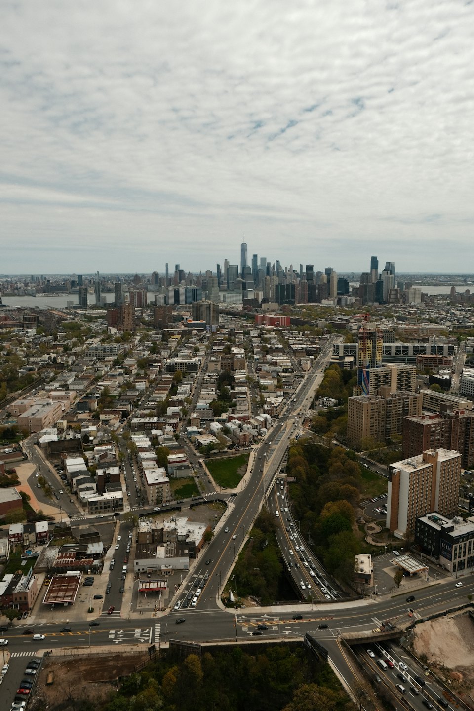 Urban residential neighborhood leading toward a distant city skyline.